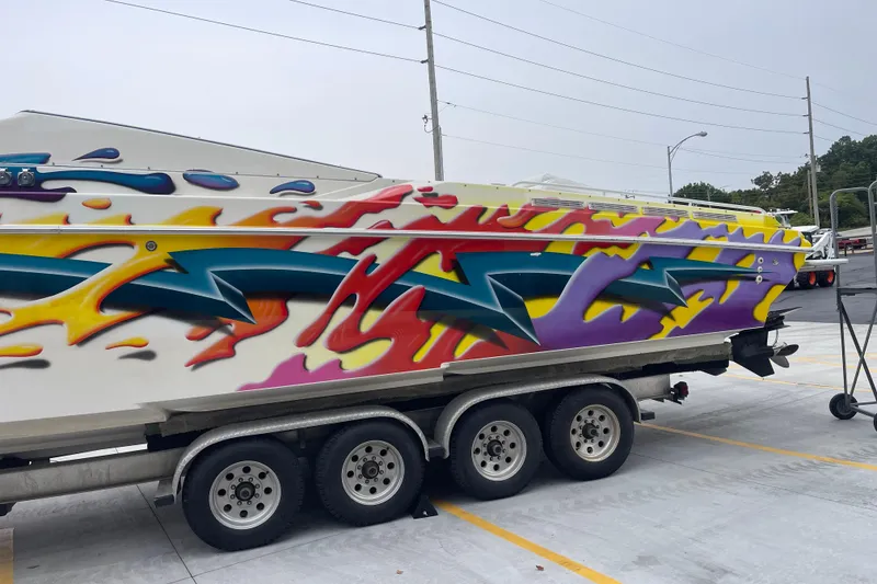 Slide: The Image of Colorful 1998 Nor-Tech 5000V Diesel boat with vibrant graffiti design on trailer. - 7