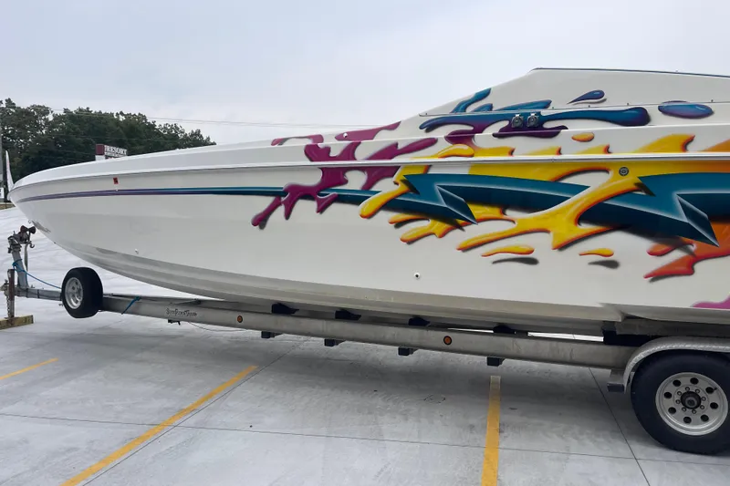 Slide: The Image of 1998 Nor-Tech 5000V Diesel boat with vibrant graffiti-style design on trailer. - 8