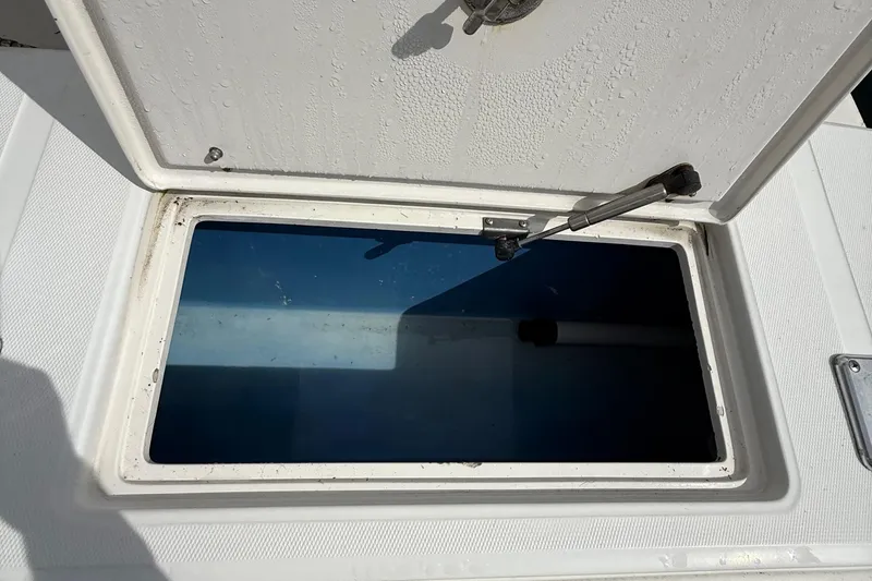 Slide: The Image of Open storage compartment on a 2007 Jupiter 31 boat, showing interior details. - 11