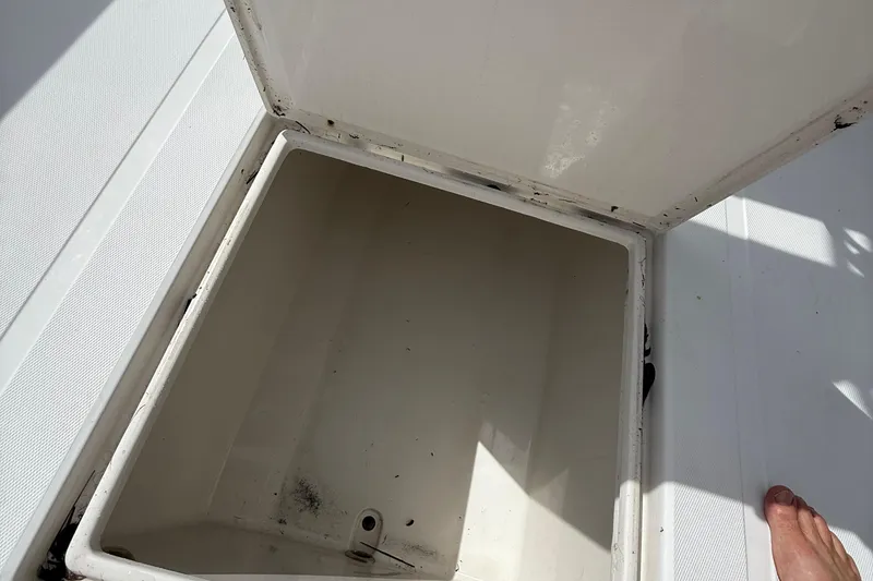 Slide: The Image of Open storage compartment on a 2007 Jupiter 31 boat, showing interior details. - 12