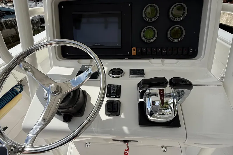 Slide: The Image of Control panel of a 2007 Jupiter 31 boat with steering wheel and gauges. - 15