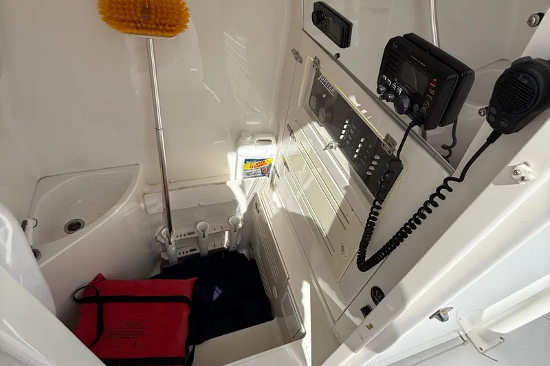 Slide: The Image of 2007 Jupiter 31 boat interior with control panel, cleaning supplies, and safety equipment. - 16
