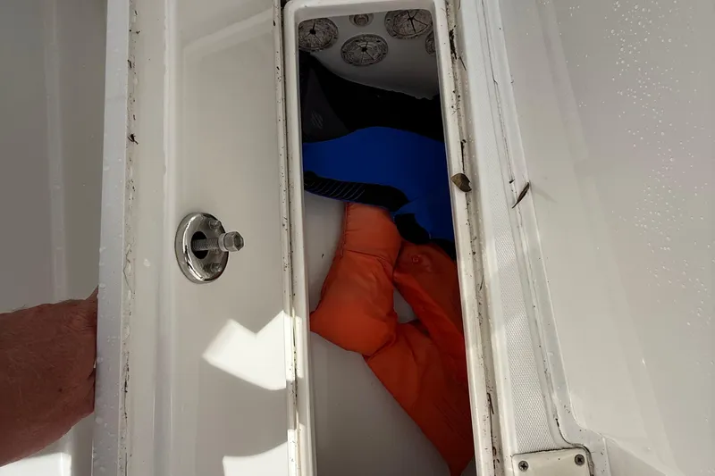 Slide: The Image of Boat storage compartment with orange and blue gear, Jupiter 31, 2007 model. - 17