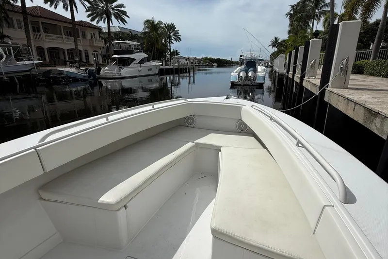 Slide: The Image of 2007 Jupiter 31 boat docked in a scenic marina with palm trees. - 23