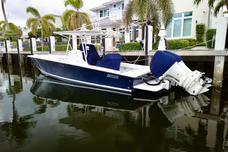 Slide: The Image of 2007 Jupiter 31 boat docked by waterfront homes, surrounded by palm trees. - 3