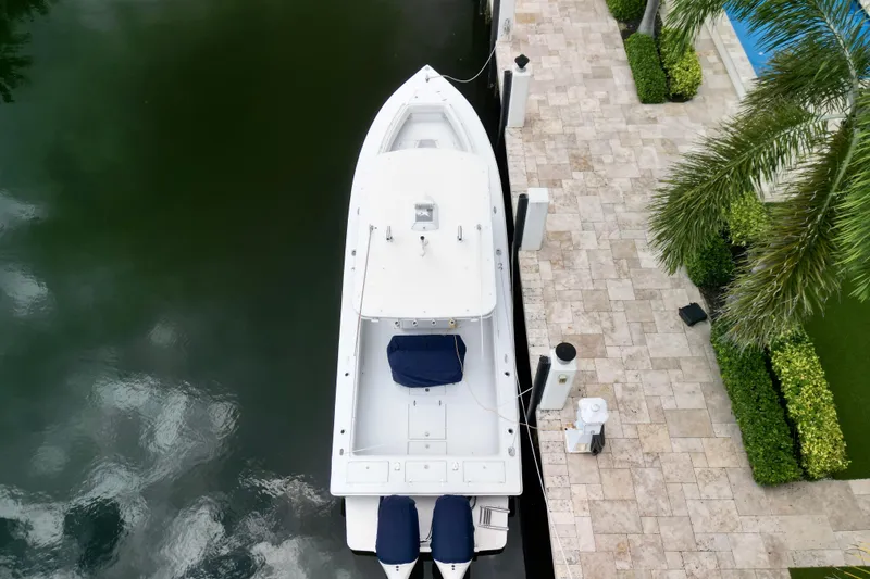 Slide: The Image of Aerial view of a 2007 Jupiter 31 boat docked beside a stone patio with lush greenery. - 4