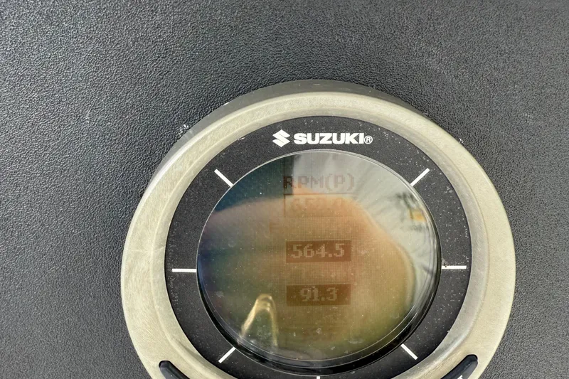 Slide: The Image of Suzuki gauge displaying RPM and speed on a 2007 Jupiter 31 boat. - 6