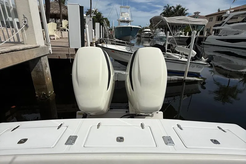 Slide: The Image of 2007 Jupiter 31 boat with dual outboard motors docked at a marina. - 9