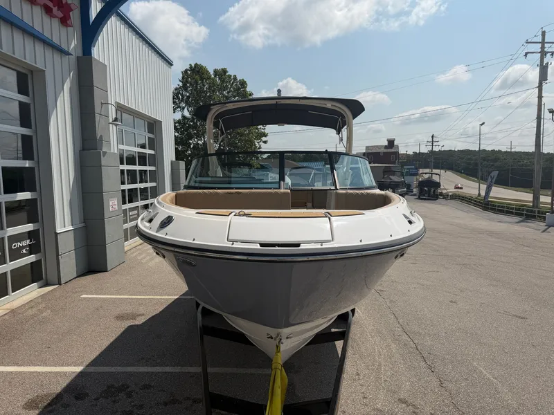 Slide: The Image of A 2026 Sea Ray SDX 250 Outboard is parked in front of a building on a lot. - 5