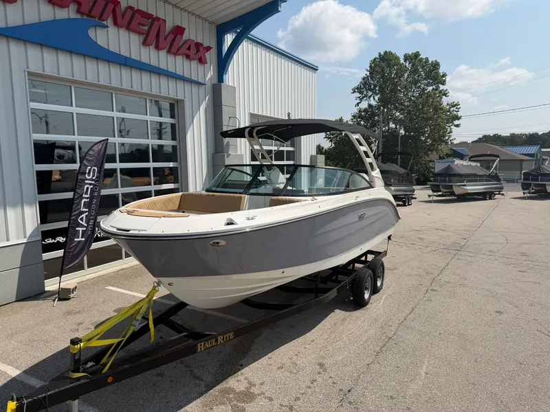 Slide: The Image of A 2026 Sea Ray SDX 250 Outboard on a trailer in front of a building. - 1