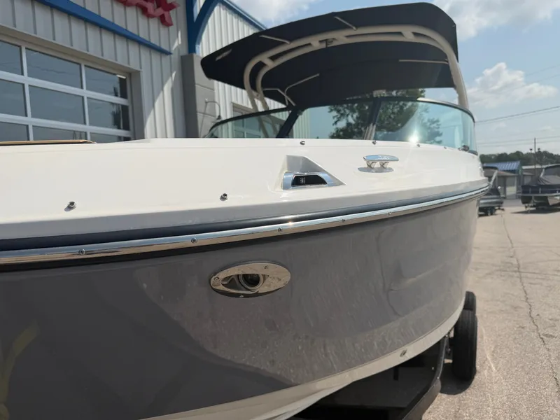 Slide: The Image of A 2026 Sea Ray SDX 250 Outboard on a trailer in front of a building. - 8