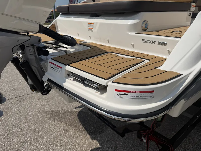 Slide: The Image of The image shows the stern of a 2026 Sea Ray SDX 250 Outboard with teak decking. - 14