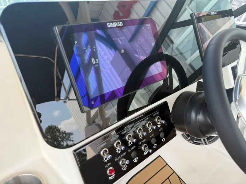 Slide: The Image of The image shows the dashboard of a Sea Ray SDX 250 Outboard with a Simrad display. - 40