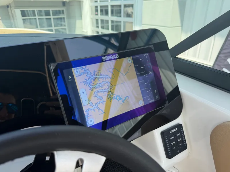 Slide: The Image of The image shows a Simrad navigation system on a 2026 Sea Ray SDX 250 Outboard. - 41