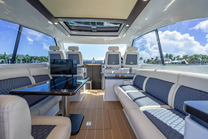 Slide: The Image of Luxurious interior of 2019 Palm Beach Motor Yachts GT50, featuring elegant seating and panoramic windows. - 2