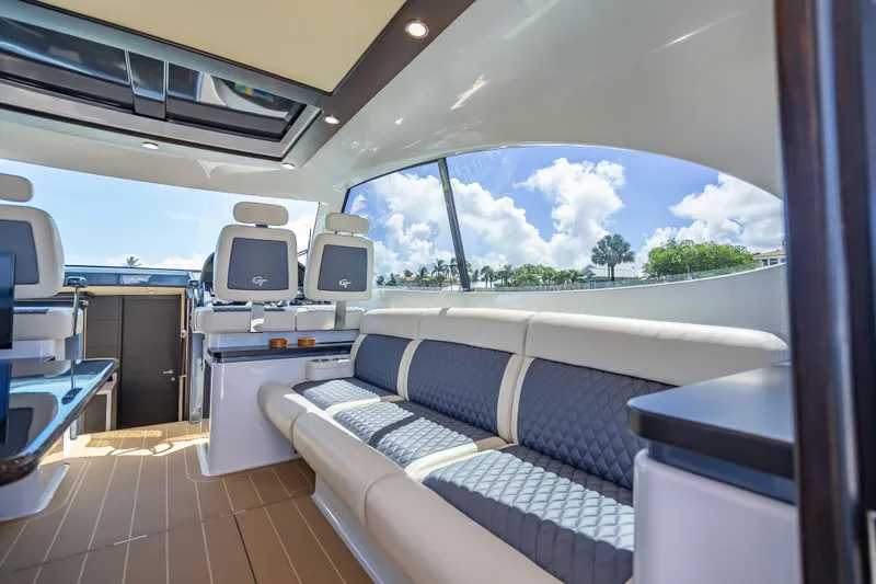 Slide: The Image of Luxurious interior of 2019 Palm Beach Motor Yachts GT50 with elegant seating and panoramic windows. - 23