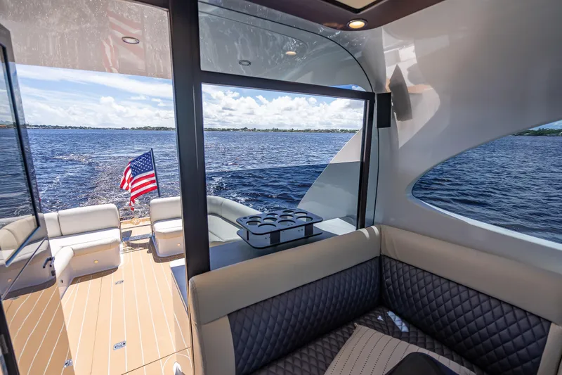 Slide: The Image of Luxurious interior of 2019 Palm Beach Motor Yachts GT50 with ocean view and American flag. - 24