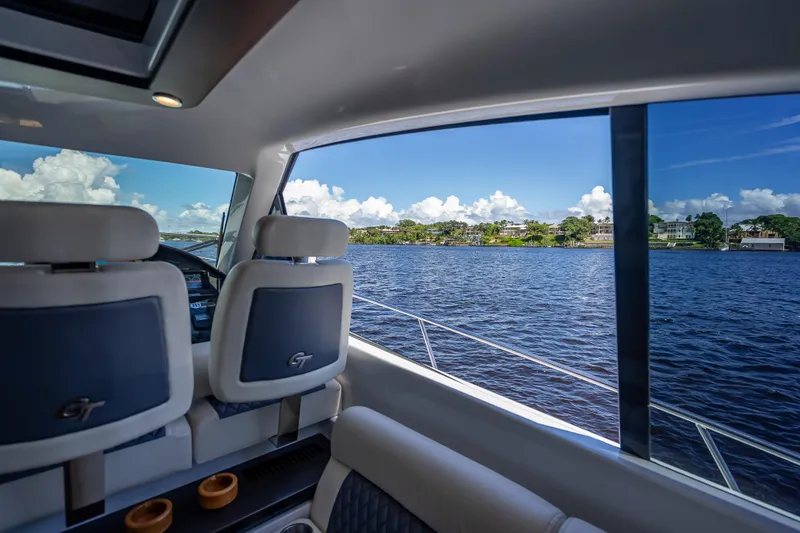 Slide: The Image of Interior view of 2019 Palm Beach Motor Yachts GT50 overlooking serene waters. - 26