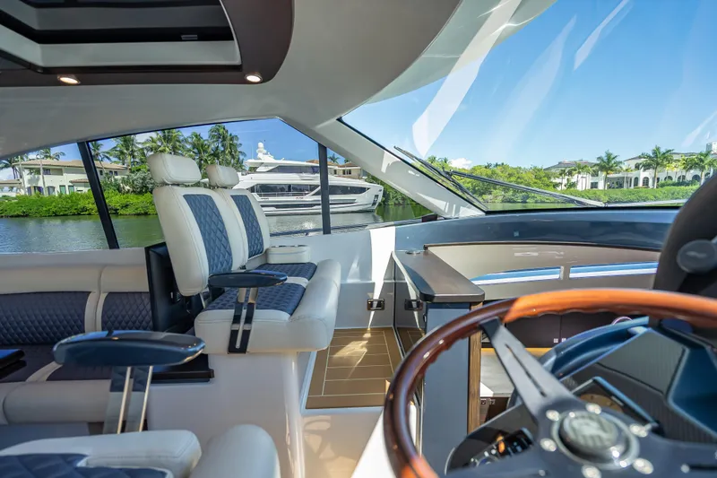 Slide: The Image of Interior of 2019 Palm Beach Motor Yachts GT50 with luxurious seating and scenic water view. - 27