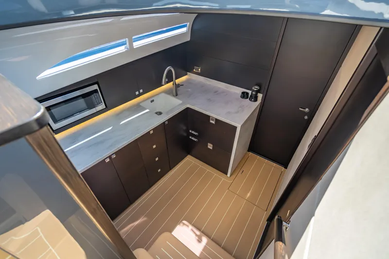 Slide: The Image of 2019 Palm Beach Motor Yachts GT50 interior kitchen with modern design and sleek cabinetry. - 32