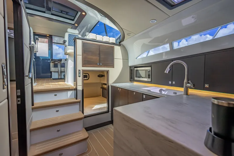Slide: The Image of Luxurious interior of 2019 Palm Beach Motor Yachts GT50, featuring modern kitchen and seating area. - 33