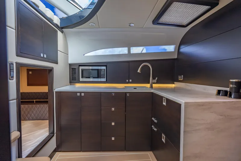 Slide: The Image of Luxurious 2019 Palm Beach Motor Yachts GT50 interior kitchen with modern cabinetry and appliances. - 37