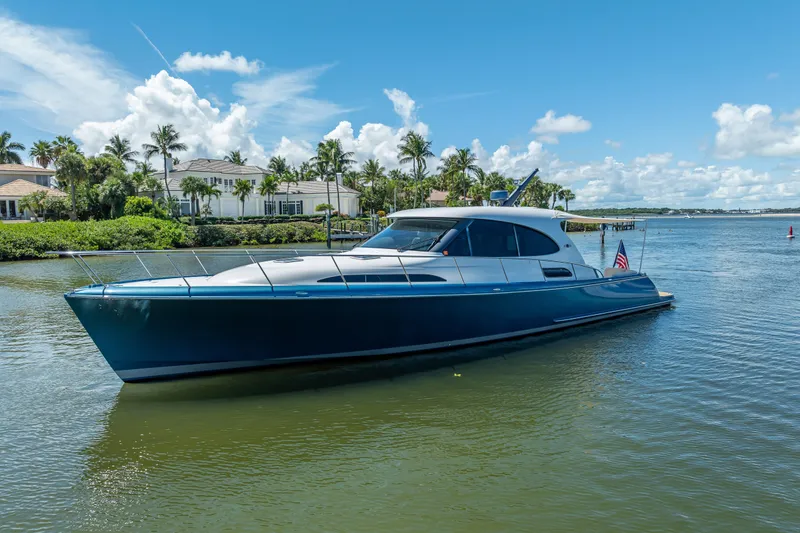 Slide: The Image of 2019 Palm Beach Motor Yachts GT50 cruising on a sunny day near waterfront homes. - 4