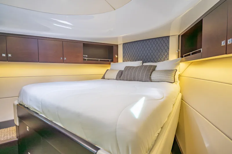 Slide: The Image of Luxurious cabin interior of 2019 Palm Beach Motor Yachts GT50, featuring elegant bedding and wood cabinetry. - 42