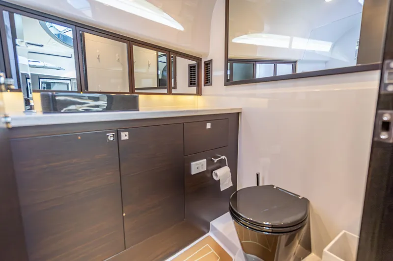 Slide: The Image of Luxurious bathroom in 2019 Palm Beach Motor Yachts GT50, featuring sleek cabinetry and modern fixtures. - 46
