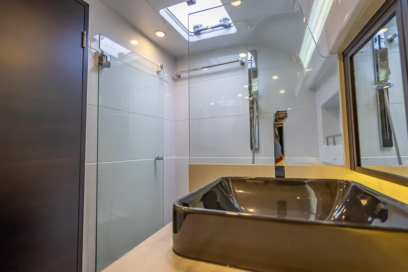 Slide: The Image of Luxurious bathroom in 2019 Palm Beach Motor Yachts GT50, featuring modern sink and shower. - 48
