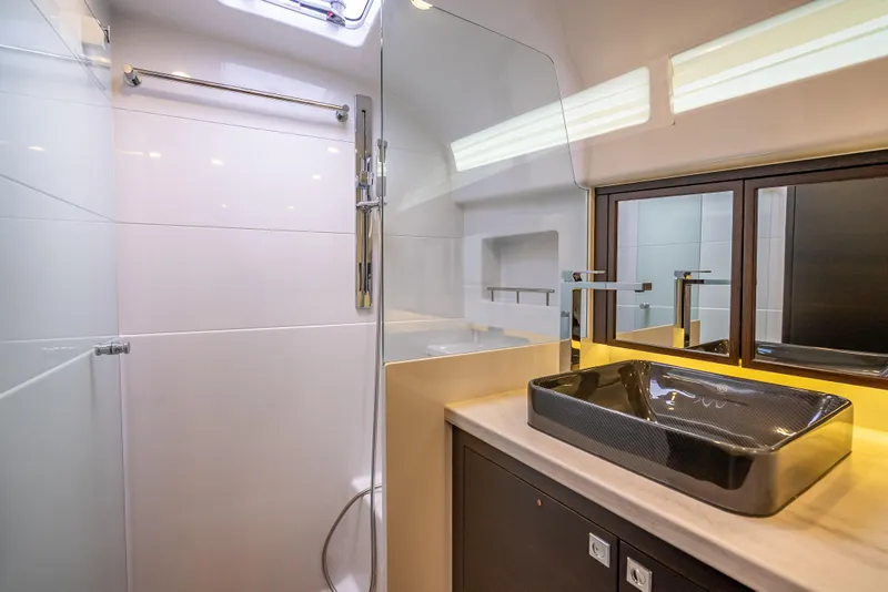Slide: The Image of Luxurious bathroom in 2019 Palm Beach Motor Yachts GT50, featuring modern sink and shower. - 50