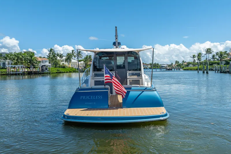 Slide: The Image of 2019 Palm Beach Motor Yachts GT50 on water, rear view with American flag. - 8