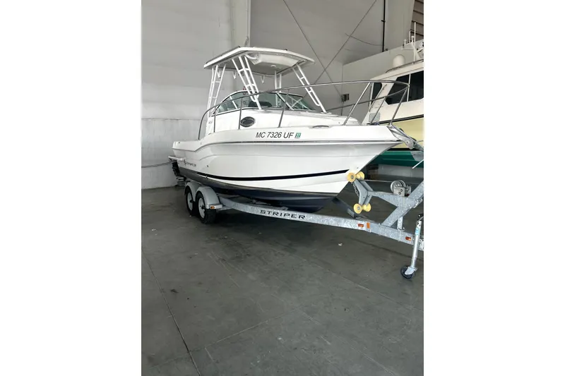 The Image of 2016 Striper 200 Walkaround boat on trailer in indoor storage. - 1
