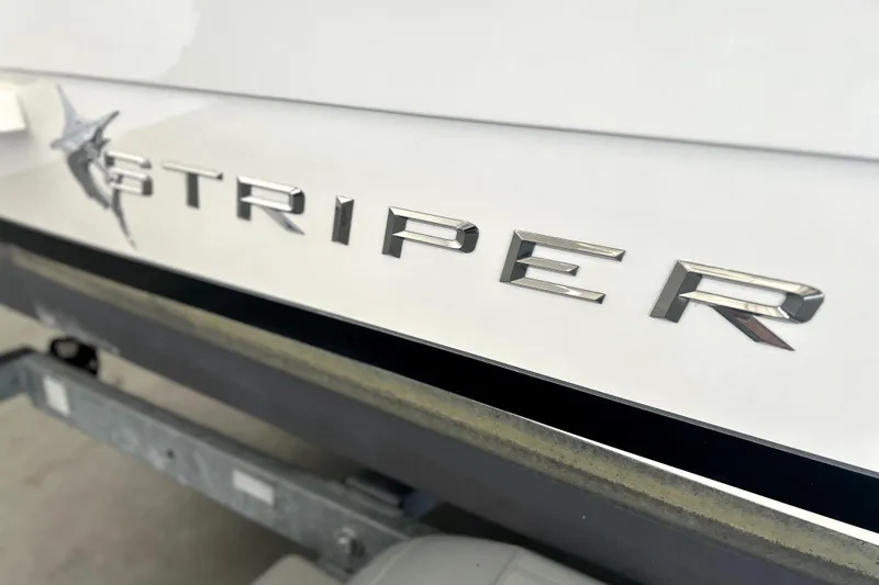 Slide: The Image of 2016 Striper 200 Walkaround boat logo on white surface. - 11