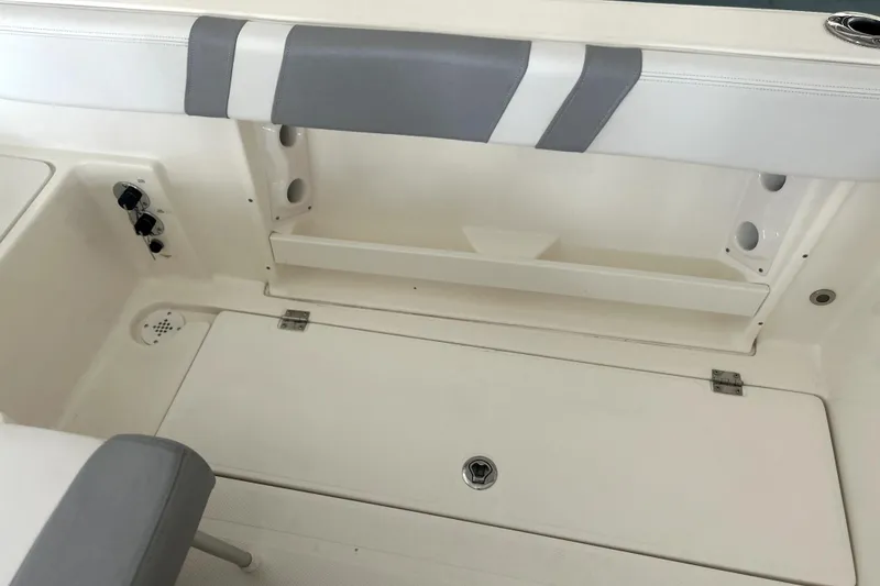 Slide: The Image of 2016 Striper 200 Walkaround boat interior with seating and storage compartments. - 13