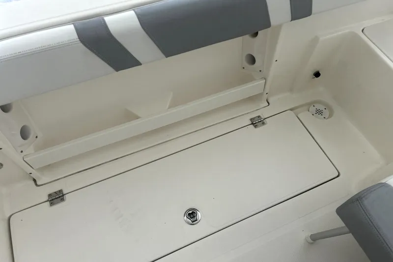 Slide: The Image of 2016 Striper 200 Walkaround boat interior with storage compartment and seating. - 14