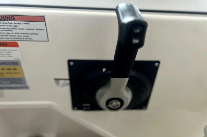 Slide: The Image of Throttle control lever on a 2016 Striper 200 Walkaround boat dashboard. - 16