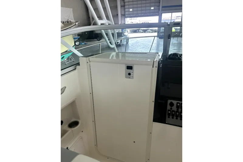 Slide: The Image of 2016 Striper 200 Walkaround boat interior with control panel and storage compartment. - 17