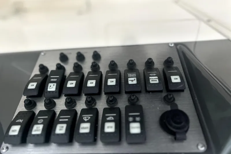 Slide: The Image of Control panel of a 2016 Striper 200 Walkaround boat with labeled switches. - 18