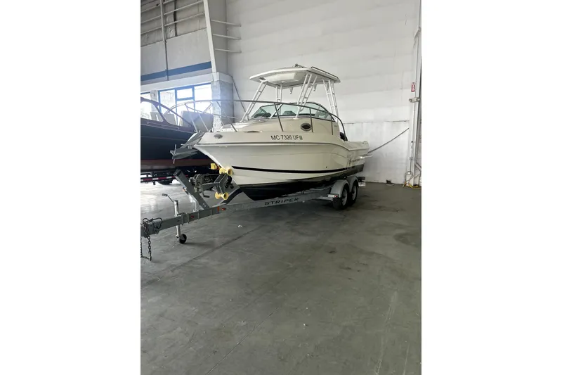Slide: The Image of 2016 Striper 200 Walkaround boat on trailer in indoor storage facility. - 2