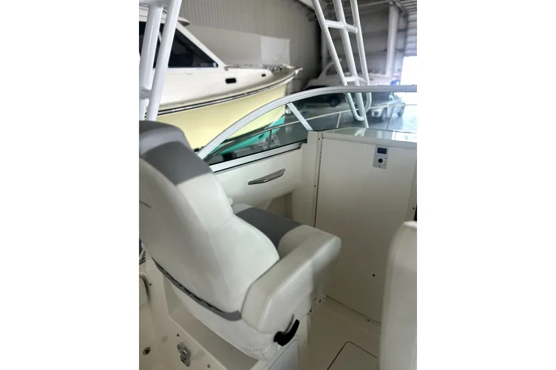 Slide: The Image of 2016 Striper 200 Walkaround boat interior with white seating and helm station. - 20