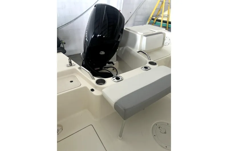 Slide: The Image of 2016 Striper 200 Walkaround boat interior with engine and seating area. - 6