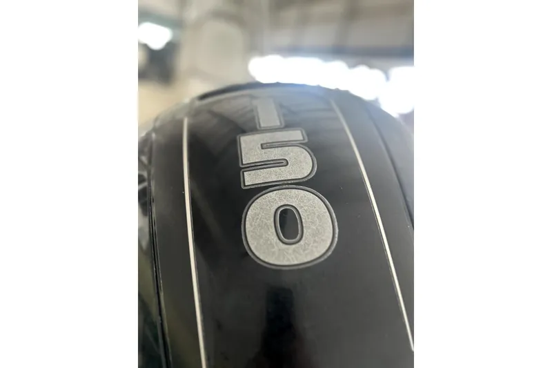 Slide: The Image of Close-up of a 150 HP engine on a 2016 Striper 200 Walkaround boat. - 8