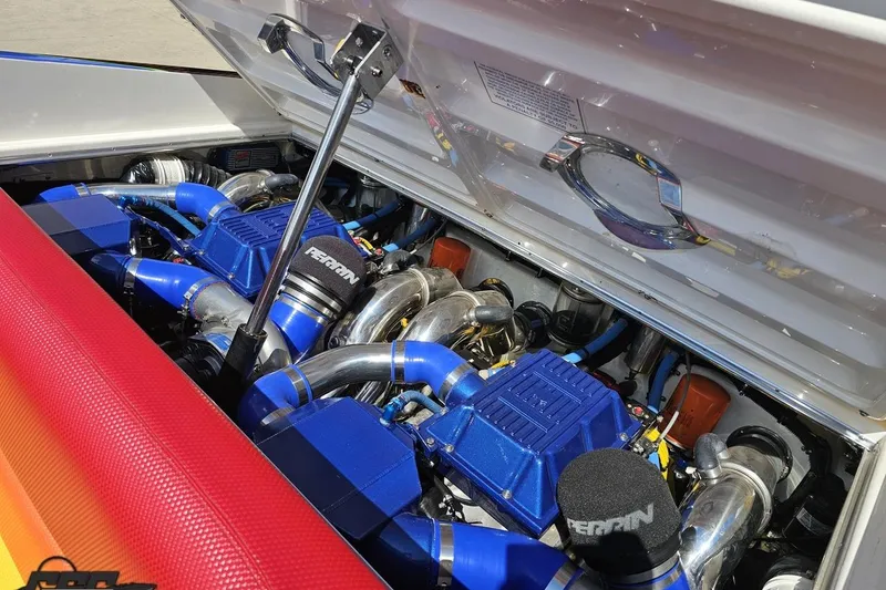Slide: The Image of 1995 Wellcraft 29 Scarab engine bay with vibrant blue and chrome components. - 102