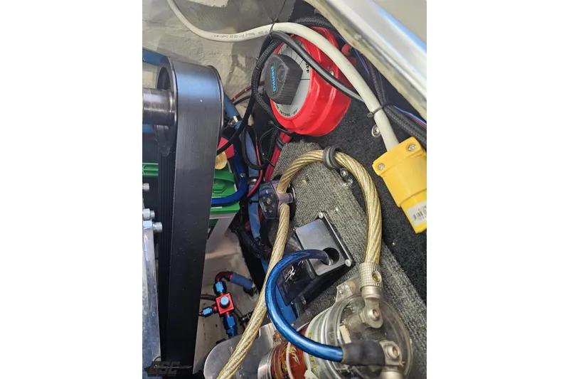 Slide: The Image of Engine compartment of a 1995 Wellcraft 29 Scarab with visible wiring and components. - 103