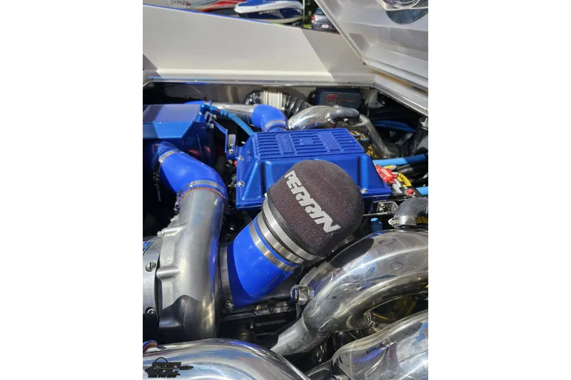 Slide: The Image of Engine of 1995 Wellcraft 29 Scarab with blue components and Perrin air filter. - 105