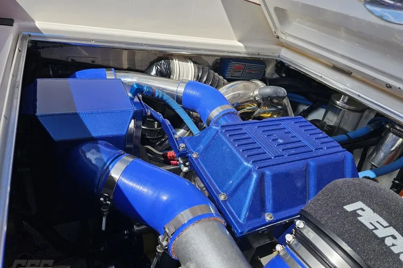 Slide: The Image of Engine compartment of a 1995 Wellcraft 29 Scarab with blue components. - 106