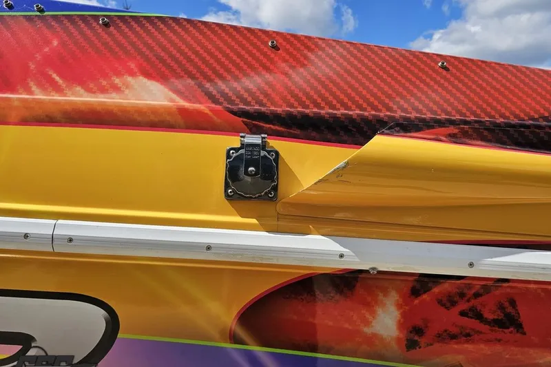 Slide: The Image of Close-up of 1995 Wellcraft 29 Scarab boat with vibrant yellow and red design. - 28