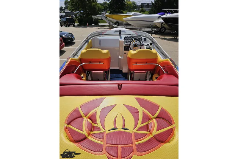 Slide: The Image of 1995 Wellcraft 29 Scarab boat interior with vibrant red and yellow seating design. - 37