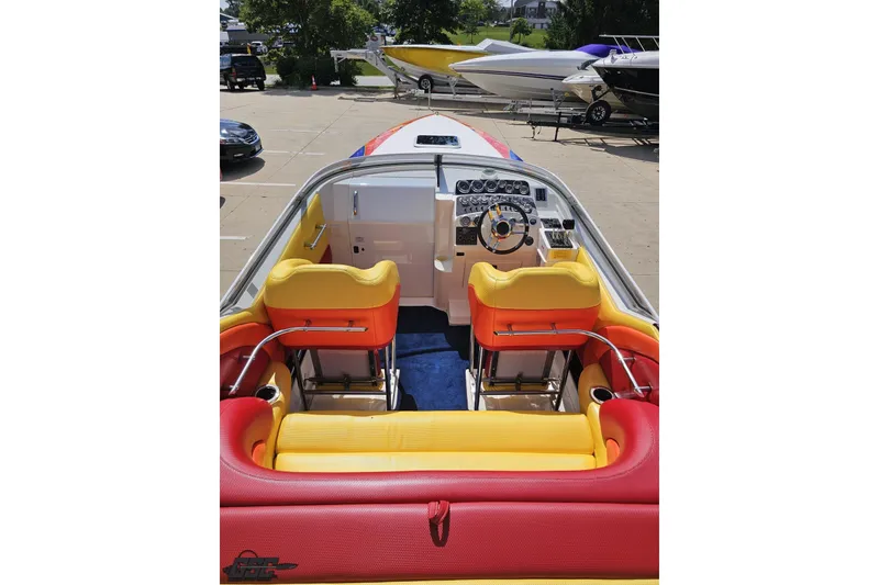 Slide: The Image of 1995 Wellcraft 29 Scarab boat interior with vibrant red and yellow seating. - 42